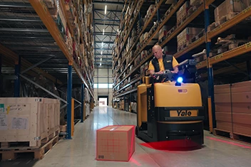 Forklift operator drives a warehouse truck. The Yale Reliant system detects a hazard.