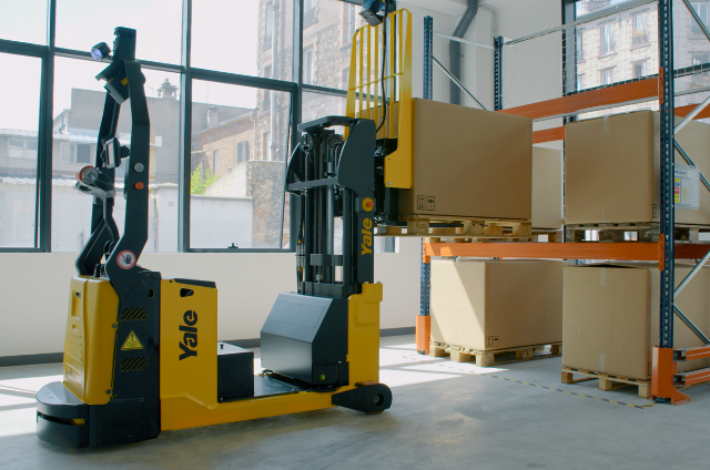 Robotic reach truck places a package onto a warehouse rack