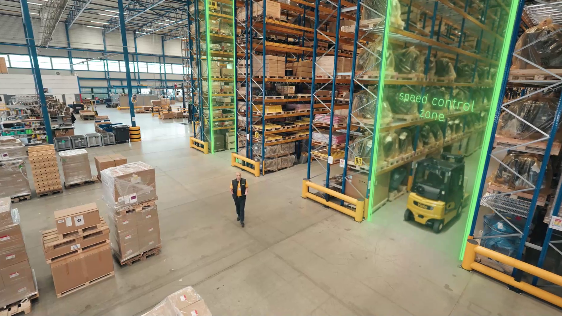 A Yale forklift is blocked from encountering a virtually speed controlled zone near a warehouse worker