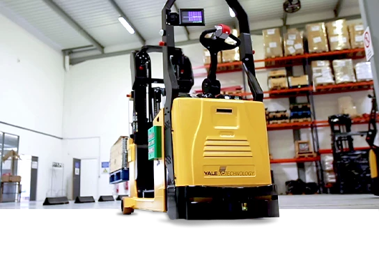 Robotic CB stacker pulling a pallet in a warehouse