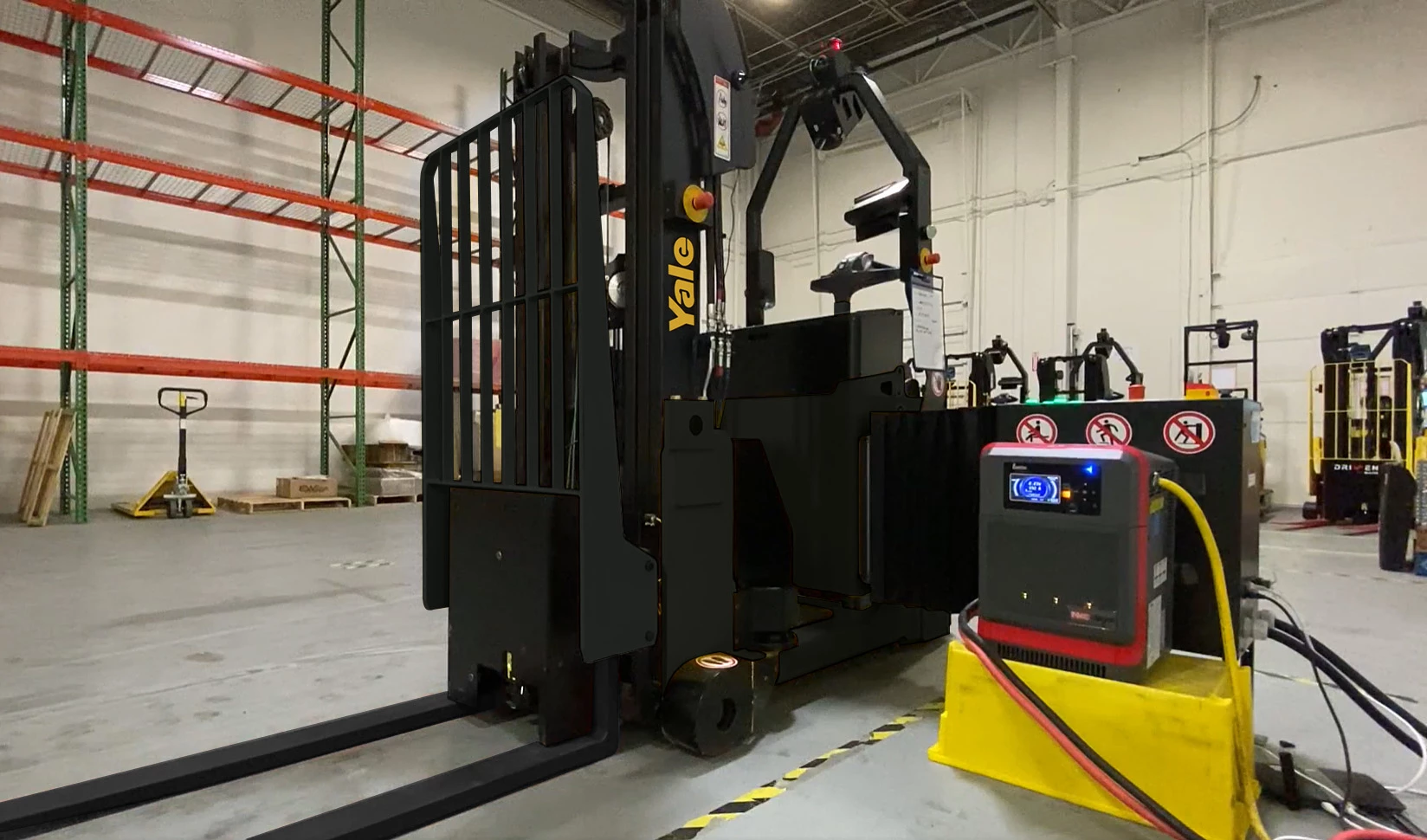 A Yale robotic counterbalanced stacker using an auto charging station in a warehouse | Automated counterbalanced stacker 