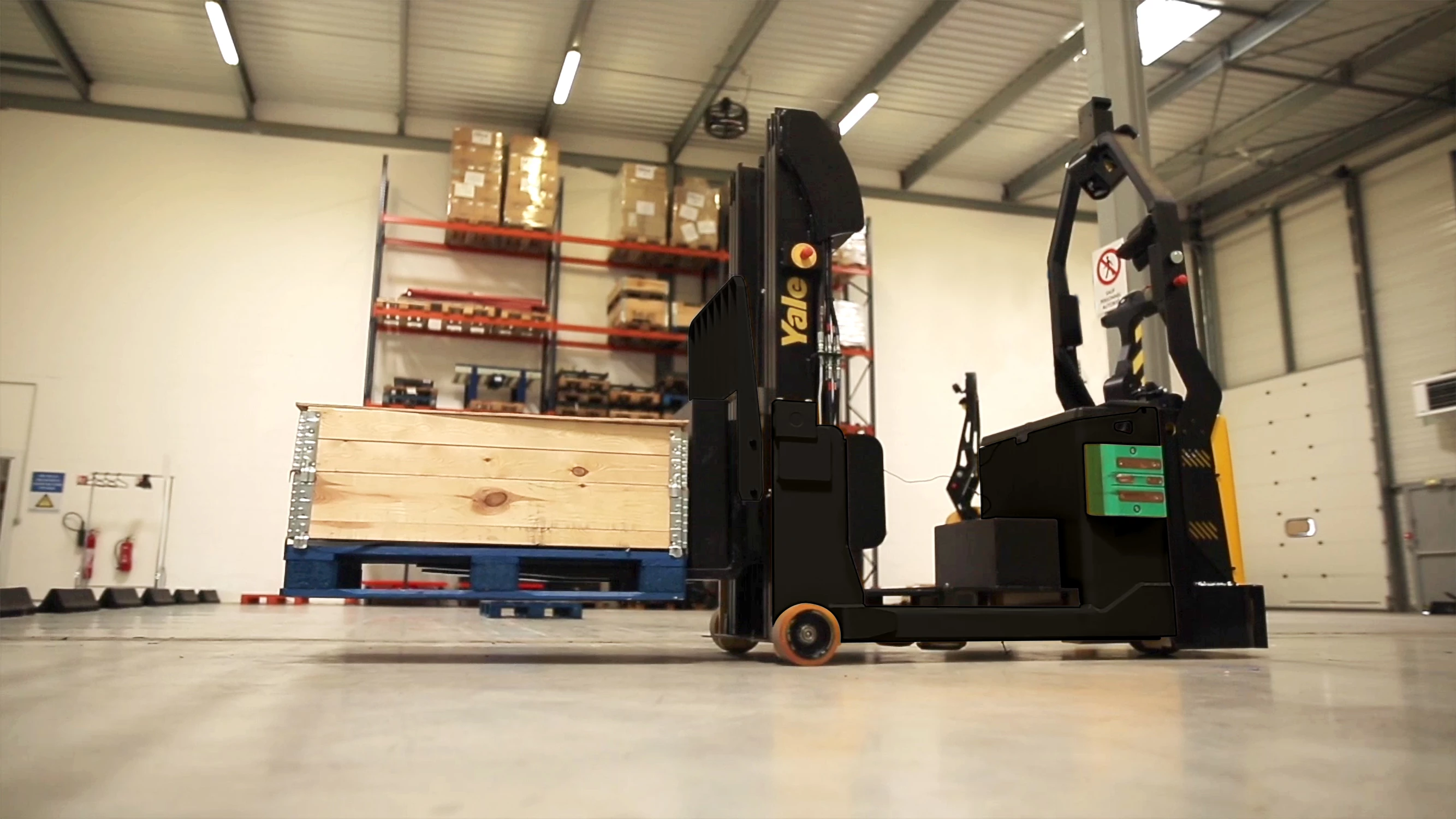 View from the ground of a Yale robotic counterbalanced stacker carrying a pallet